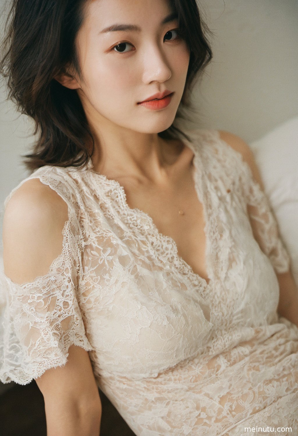 Half-body portrait of an adult asian woman with gentle waves and sand, light and shadow defining her elegant curves.